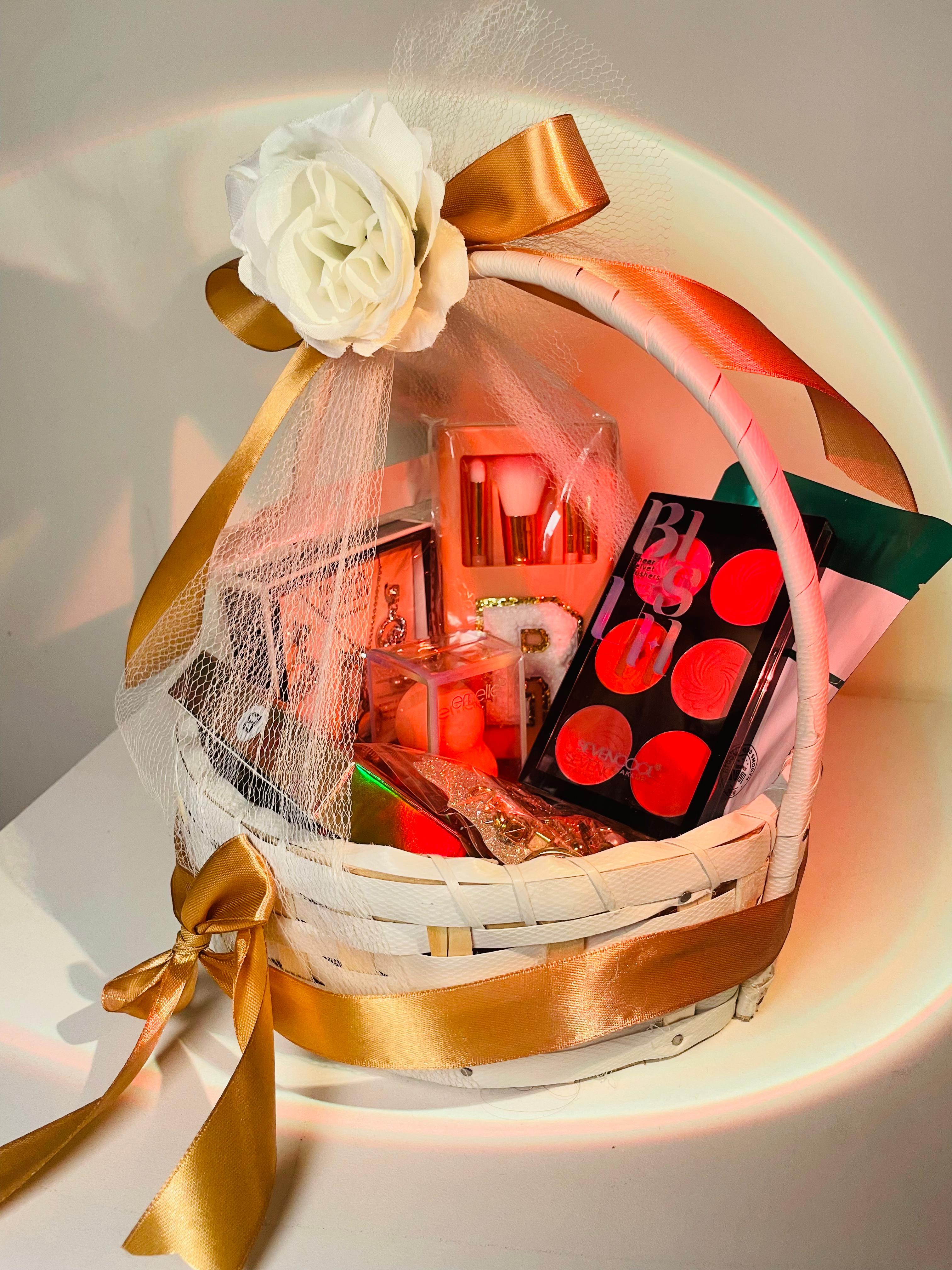 Gift basket with makeup items and a white flower on a light background